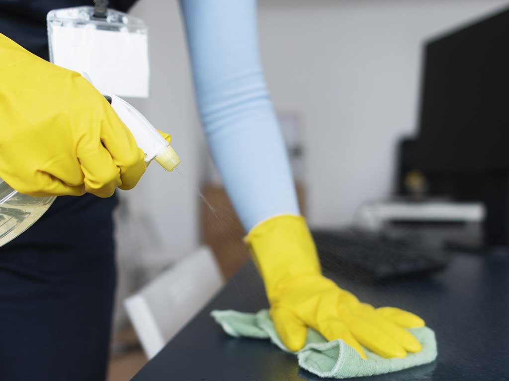 Andrew’s Magic Touch Cleaning employee demonstrates industry-standard guidelines for surface disinfection to eliminate viruses and bacteria.