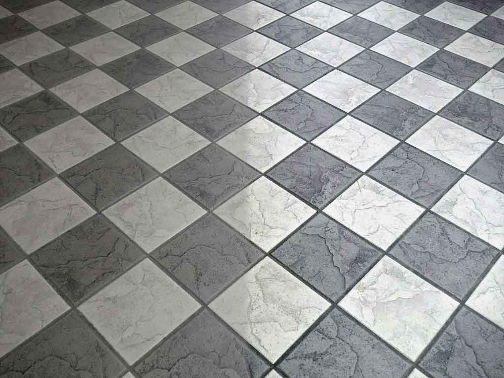 Photographic rendition of a tile floor halfway through  deep cleaning.